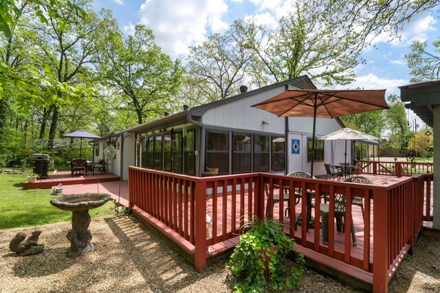 16 Valley Rd, Cabot, AR 72023 - wooden terrace with outdoor dining area and a sunroom