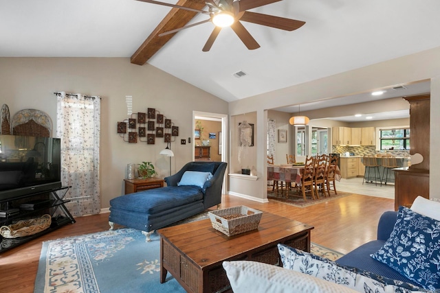16 Valley Rd, Cabot, AR 72023 - living area with visible vents, light wood-style flooring, vaulted ceiling with beams, and ceiling fan
