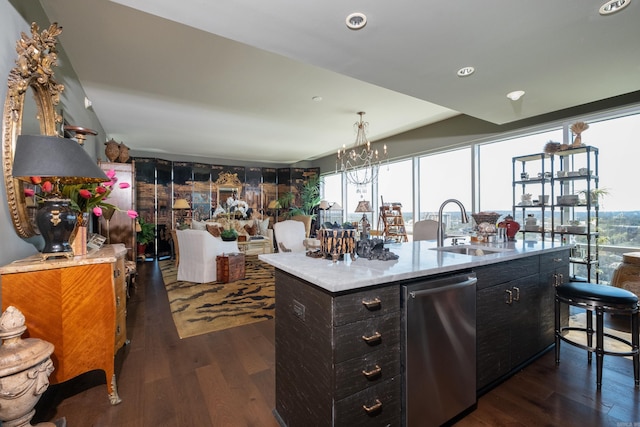 bar featuring dark wood-style flooring, an inviting chandelier, dishwasher, and a sink
