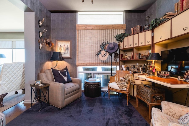 living area featuring a wealth of natural light and wood finished floors
