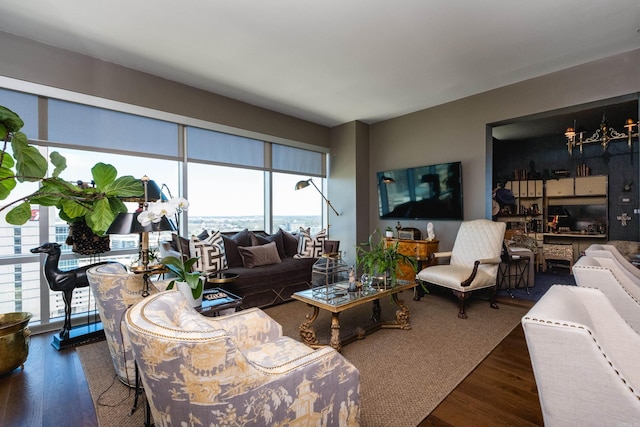 living room with a notable chandelier and wood finished floors