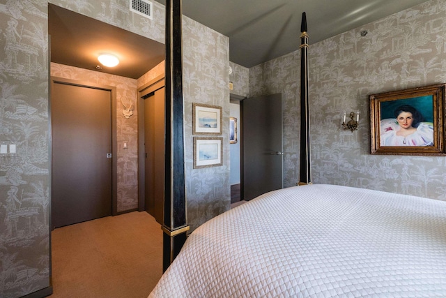 bedroom with carpet, visible vents, a closet, and wallpapered walls