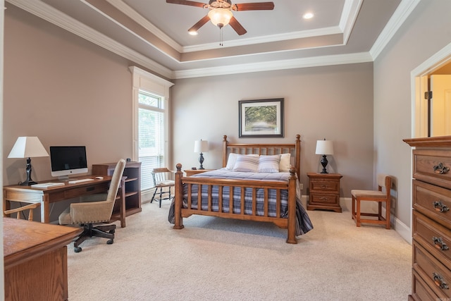 carpeted bedroom with ornamental molding, baseboards, a raised ceiling, and a ceiling fan