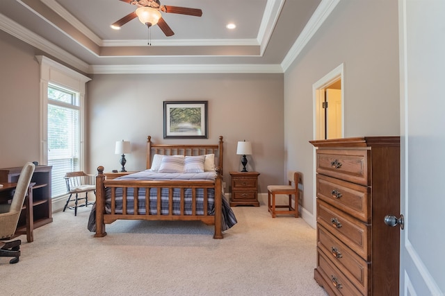 bedroom featuring light carpet, crown molding, a ceiling fan, and a raised ceiling