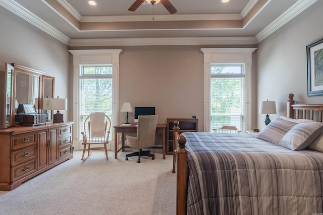 bedroom with ornamental molding, multiple windows, a raised ceiling, and light carpet