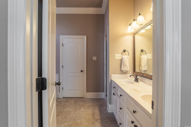 full bathroom featuring crown molding, tile patterned flooring, a sink, double vanity, and baseboards