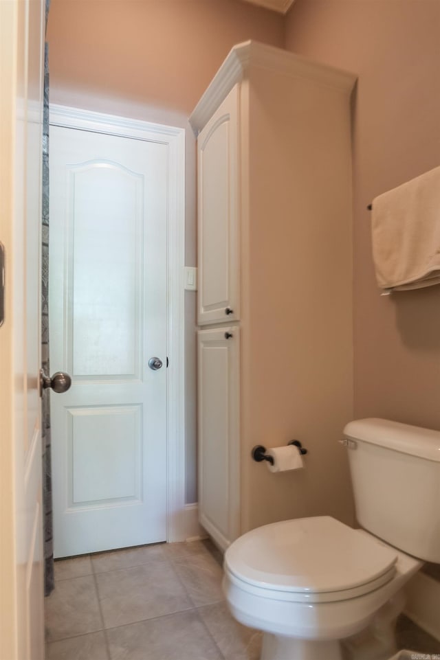 bathroom featuring toilet and tile patterned flooring