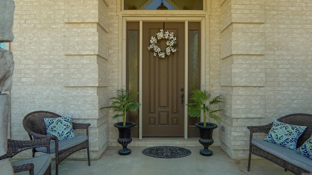 doorway to property with brick siding