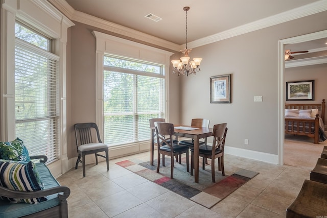 dining space featuring crown molding, plenty of natural light, and a notable chandelier