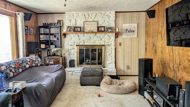 1012 Fairwater Cir, Horseshoe Bend, AR 72512 - carpeted living room with crown molding, wood walls, a fireplace, and a textured ceiling