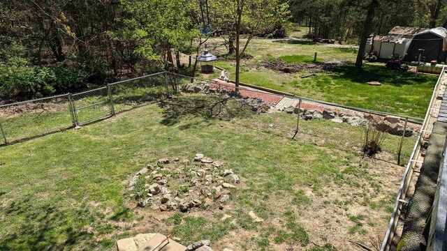 1012 Fairwater Cir, Horseshoe Bend, AR 72512 - view of yard with an outdoor structure, fence, and a gate