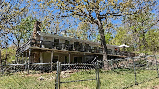 1012 Fairwater Cir, Horseshoe Bend, AR 72512 - back of house featuring a yard, a wooden deck, fence private yard, and a gate