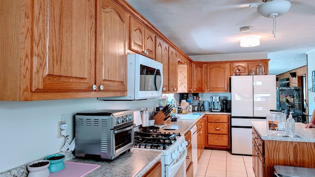 1012 Fairwater Cir, Horseshoe Bend, AR 72512 - kitchen with brown cabinets, white appliances, a toaster, and light tile patterned flooring