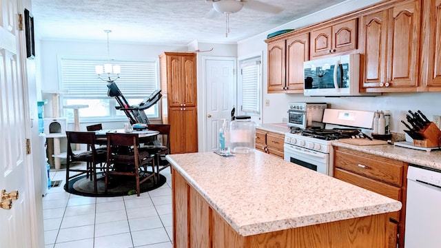 1012 Fairwater Cir, Horseshoe Bend, AR 72512 - kitchen featuring ornamental molding, light countertops, white appliances, and light tile patterned floors