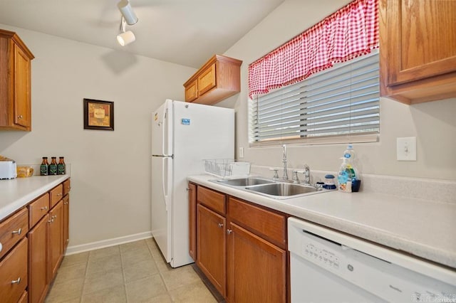 1100 Woodlawn Ave Unit K-61, Hot Springs, AR 71913 - kitchen with brown cabinetry, white appliances, light countertops, and a sink