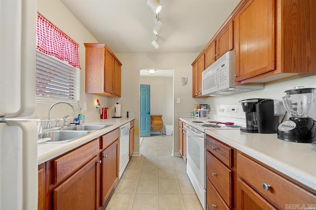 1100 Woodlawn Ave Unit K-61, Hot Springs, AR 71913 - kitchen with light tile patterned floors, white appliances, brown cabinetry, light countertops, and a sink