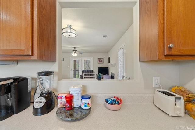 1100 Woodlawn Ave Unit K-61, Hot Springs, AR 71913 - kitchen featuring brown cabinets, visible vents, light countertops, and ceiling fan