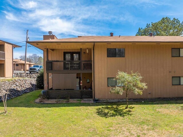 1100 Woodlawn Ave Unit K-61, Hot Springs, AR 71913 - rear view of property with a chimney, a yard, and a balcony