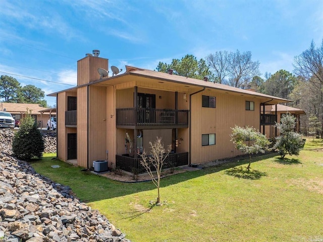 1100 Woodlawn Ave Unit K-61, Hot Springs, AR 71913 - rear view of house with a balcony, a lawn, and a chimney