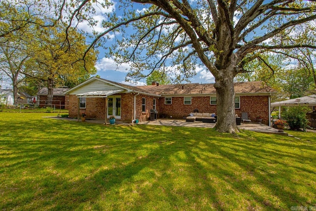 6808 Sandpiper Dr, Little Rock, AR 72205 - back of house with a patio, brick siding, a lawn, and an outdoor hangout area