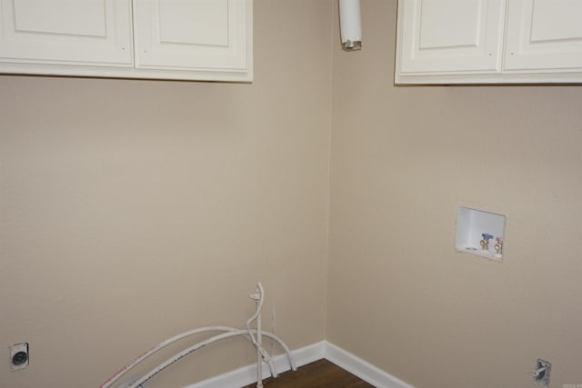 laundry area with baseboards, cabinet space, dark wood-style floors, and washer hookup