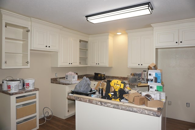 kitchen featuring open shelves, dark wood finished floors, and white cabinetry