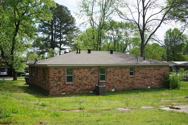 rear view of house featuring central AC, crawl space, a shingled roof, and brick siding