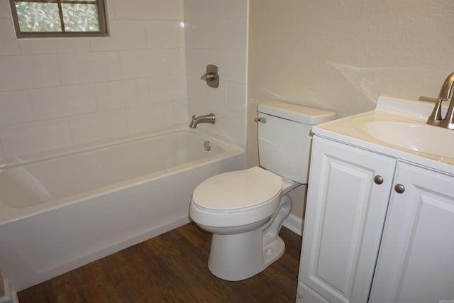 bathroom featuring toilet, vanity, wood finished floors, and shower / bath combination