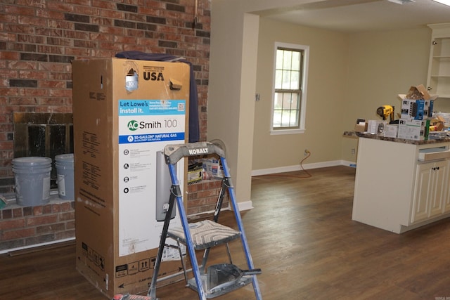 interior space featuring baseboards and wood finished floors