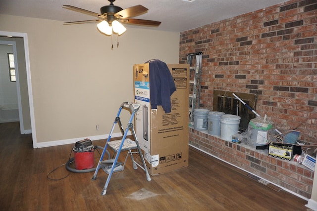 miscellaneous room featuring wood finished floors, a ceiling fan, and baseboards