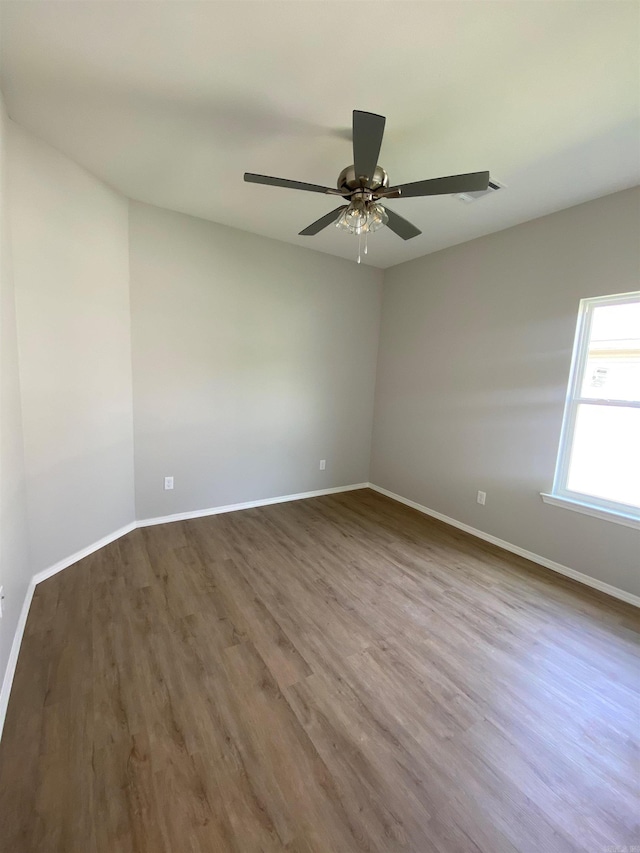 3512 Village Walk Dr, Bryant, AR 72022 - spare room featuring wood finished floors, baseboards, and a ceiling fan