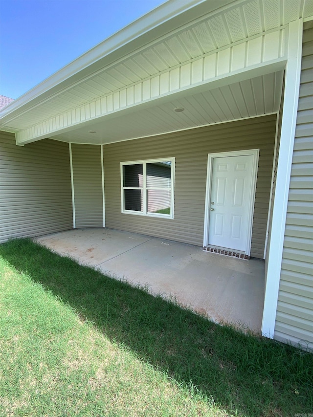 3512 Village Walk Dr, Bryant, AR 72022 - view of exterior entry with a patio area and a lawn