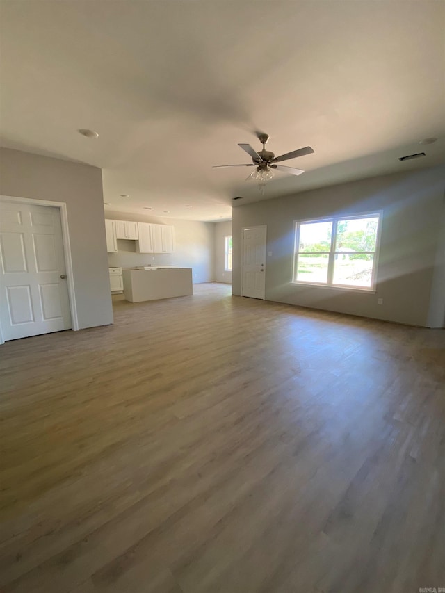 3512 Village Walk Dr, Bryant, AR 72022 - unfurnished living room featuring wood finished floors and ceiling fan