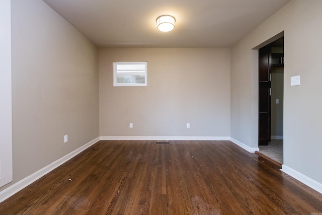 6 Broadmoor Dr, Little Rock, AR 72204 - unfurnished room featuring dark wood-style flooring, visible vents, and baseboards