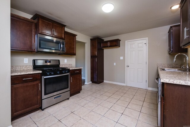 6 Broadmoor Dr, Little Rock, AR 72204 - kitchen featuring light countertops, dark brown cabinetry, a sink, and stainless steel appliances
