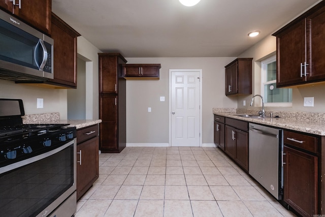 6 Broadmoor Dr, Little Rock, AR 72204 - kitchen with dark brown cabinetry, a sink, light stone counters, and appliances with stainless steel finishes