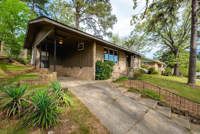 6 Broadmoor Dr, Little Rock, AR 72204 - view of front facade featuring a carport, concrete driveway, a front yard, and brick siding