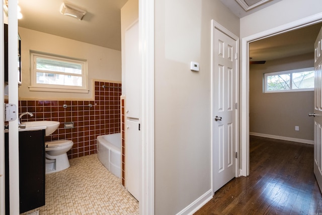 6 Broadmoor Dr, Little Rock, AR 72204 - full bathroom with tile walls, toilet, a bathtub, vanity, and a wainscoted wall