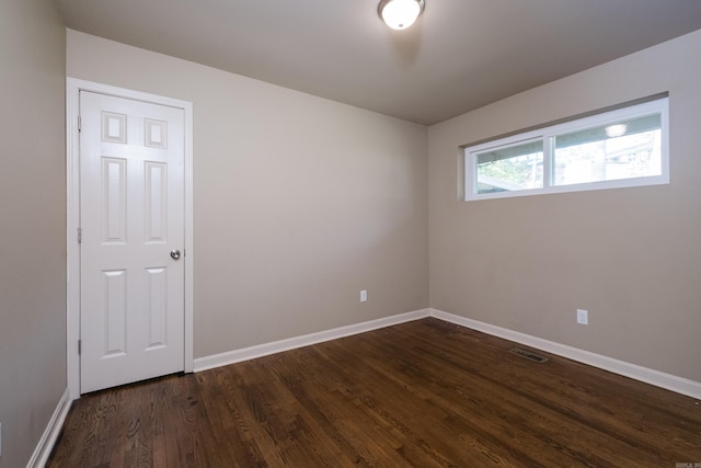6 Broadmoor Dr, Little Rock, AR 72204 - spare room featuring dark wood-type flooring, visible vents, and baseboards