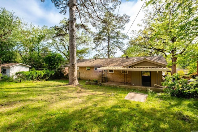 6 Broadmoor Dr, Little Rock, AR 72204 - rear view of property featuring a patio area and a lawn