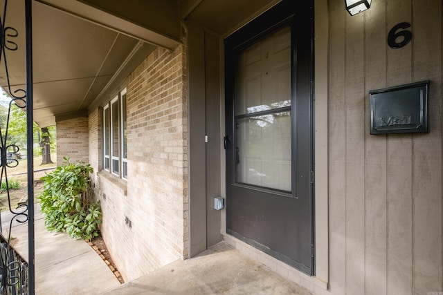 6 Broadmoor Dr, Little Rock, AR 72204 - property entrance featuring covered porch and brick siding