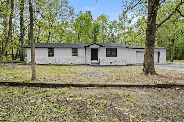 ranch-style house featuring driveway, crawl space, a front lawn, an attached garage, and entry steps