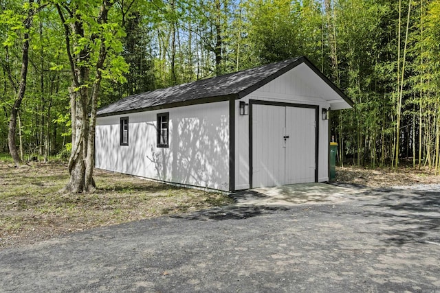 view of shed with a forest view