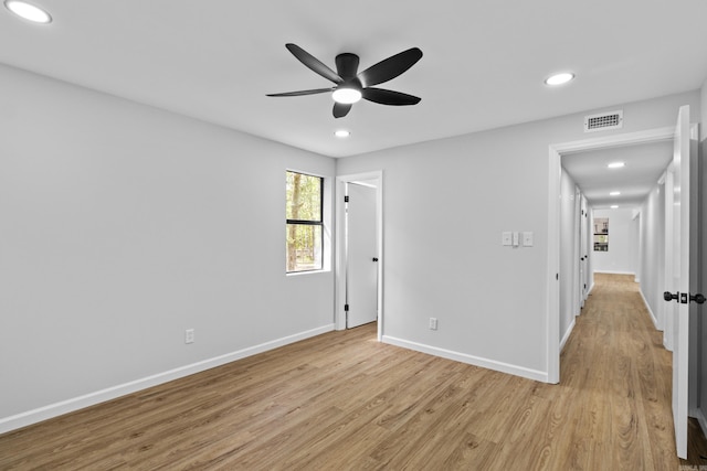 unfurnished bedroom with light wood-style floors, recessed lighting, visible vents, and baseboards