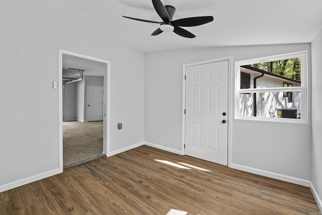 foyer entrance with wood finished floors, ceiling fan, and baseboards