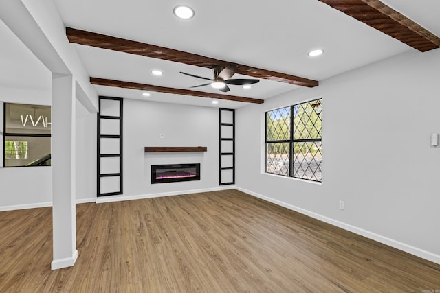 unfurnished living room featuring a healthy amount of sunlight, recessed lighting, a ceiling fan, and wood finished floors