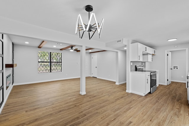 unfurnished living room with light wood-style flooring, ceiling fan with notable chandelier, and baseboards