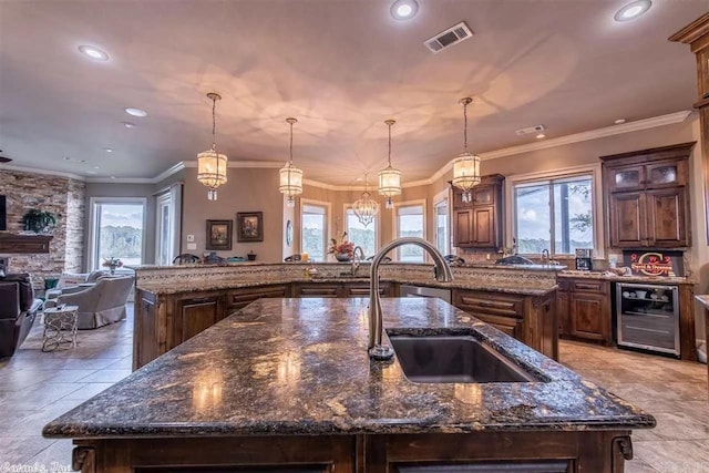 6550 Westminster, Benton, AR 72019 - kitchen with a large island with sink, a sink, beverage cooler, and a wealth of natural light