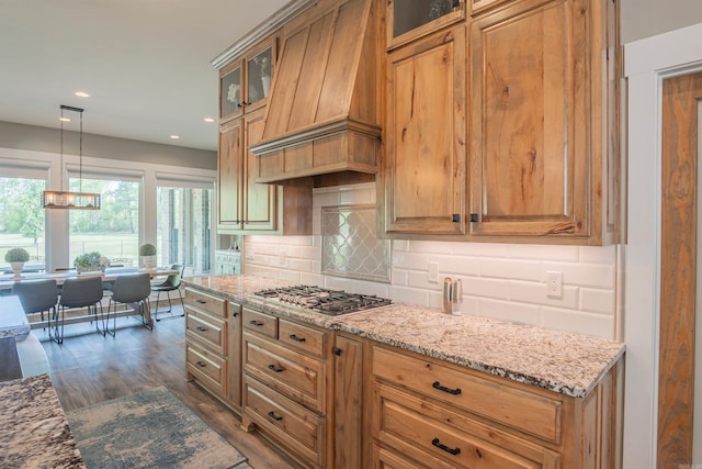 234 Barrett Ln, Cabot, AR 72023 - kitchen with glass insert cabinets, premium range hood, light stone countertops, decorative backsplash, and stainless steel gas cooktop