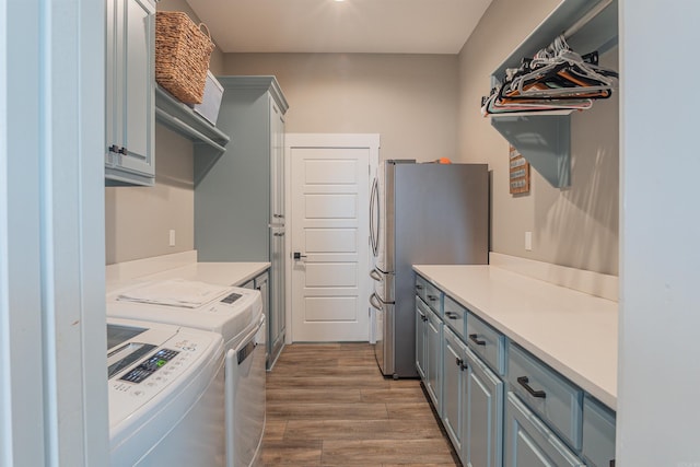 234 Barrett Ln, Cabot, AR 72023 - washroom with wood finished floors, cabinet space, and washer and clothes dryer